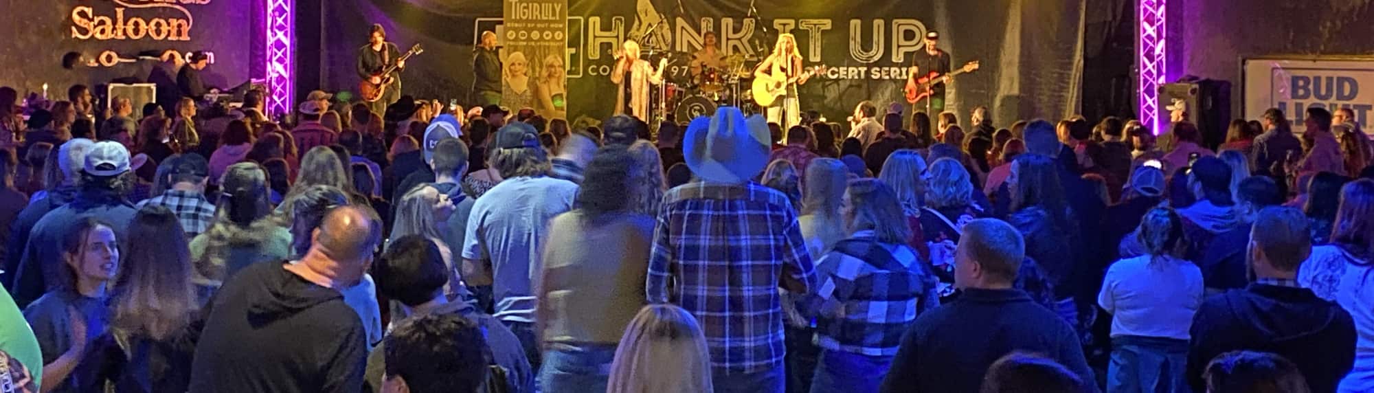 country concert with fans wearing cowboy hats Honolulu