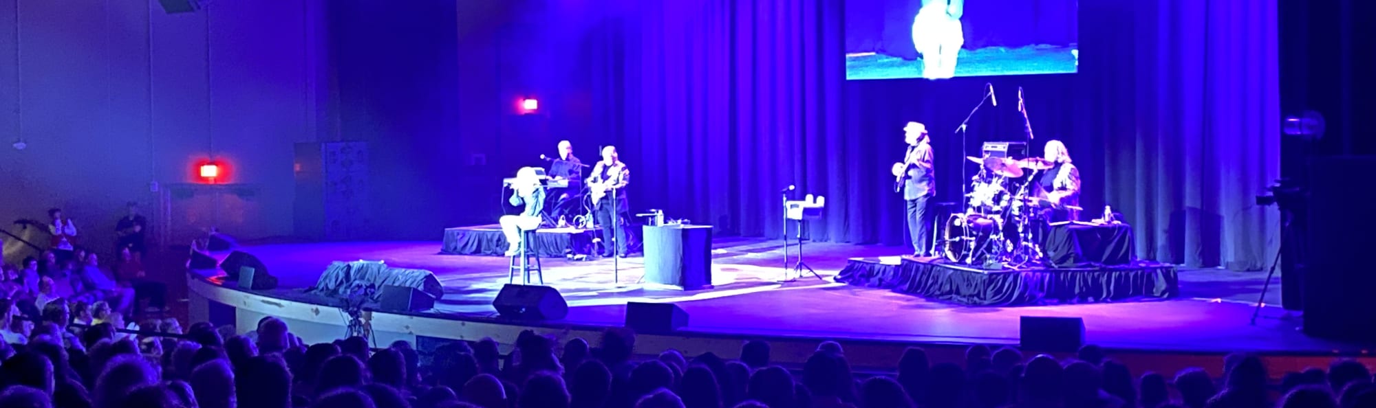signer on stage in chair washed out by the lights Honolulu